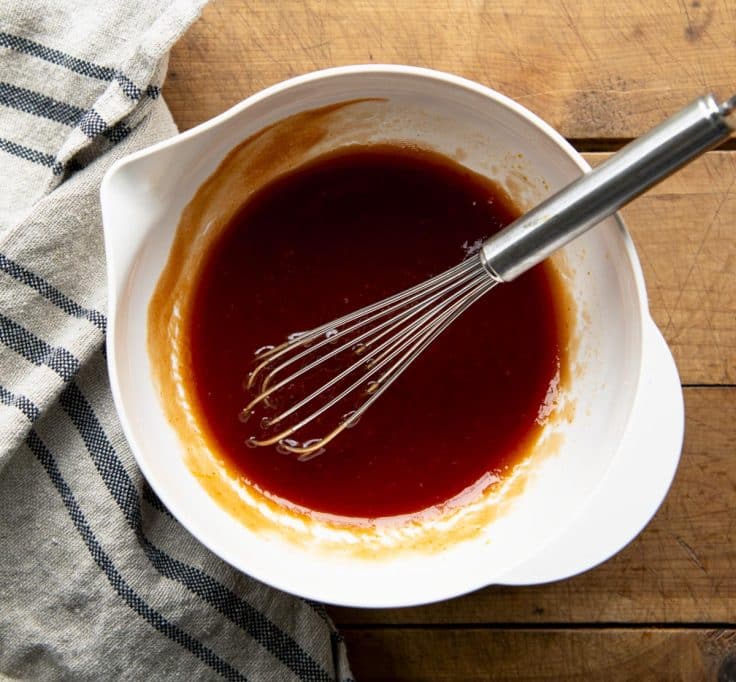 Whisking together sauce for calico beans.