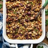 Square overhead shot of calico beans in a white dish.