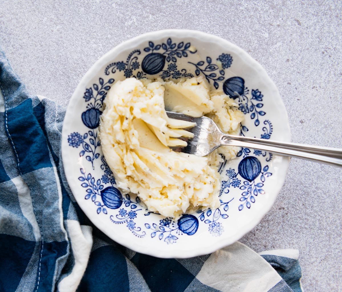 Small bowl with butter, garlic, salt, and pepper combined.