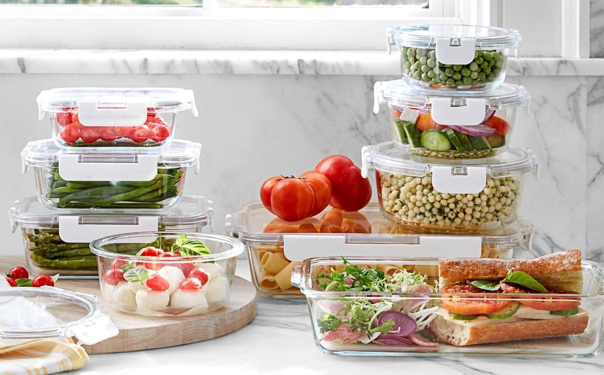 Horizontal side shot of packed lunch ideas on a white counter.
