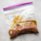Pork tenderloin in a Ziploc bag with the best pork tenderloin marinade for grilling.