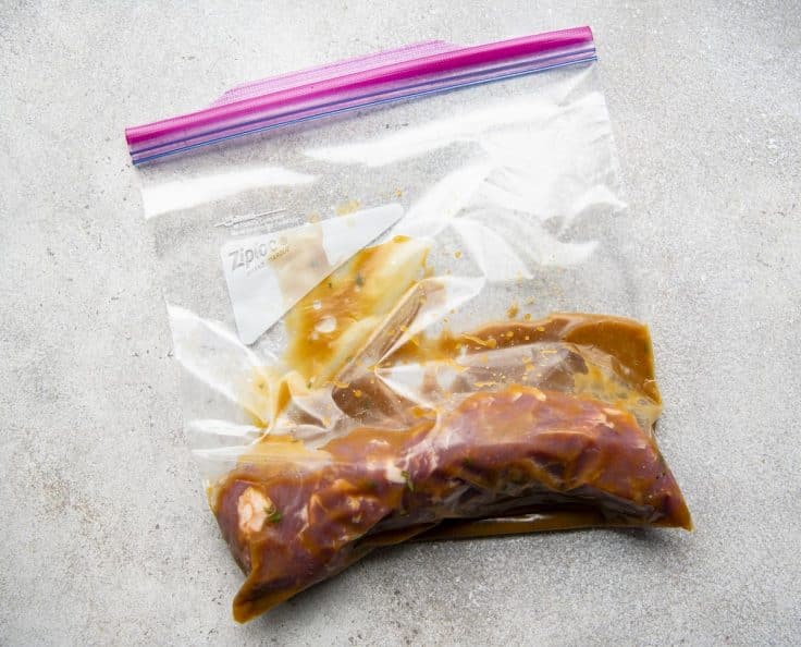 Pork tenderloin in a Ziploc bag with the best pork tenderloin marinade for grilling.