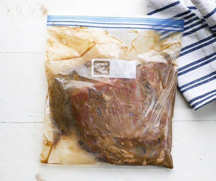 Marinating flank steak in a Ziploc bag.