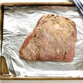 Seasoned and marinated flank steak before grilling.