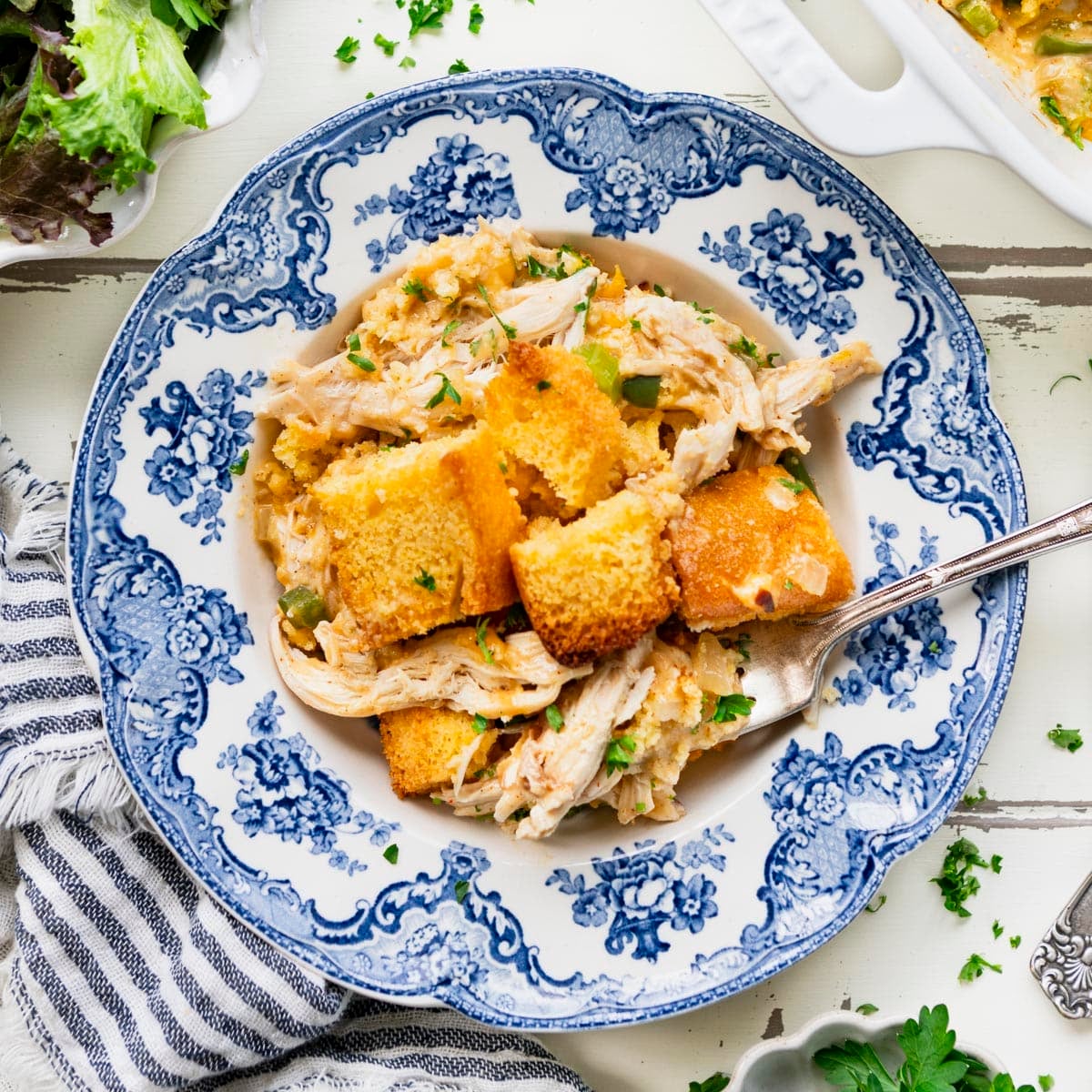 Square overhead shot of cornbread cowboy casserole in a blue and white bowl.