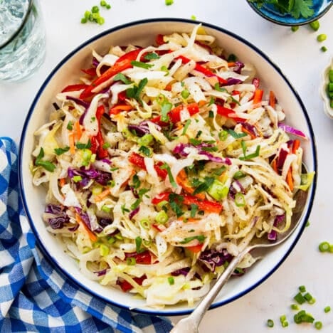 Square overhead shot of a bowl of vinegar coleslaw.