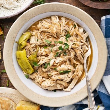 Square overhead shot of a bowl of crock pot mississippi chicken.