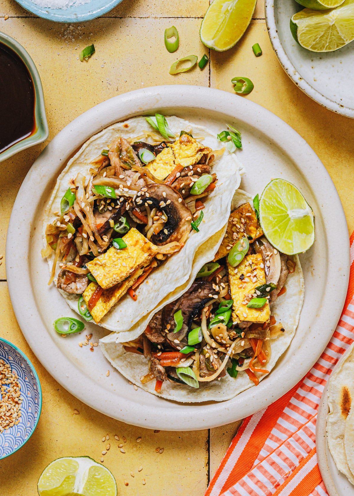 Overhead shot of moo shu pork served on a white plate in pancakes.