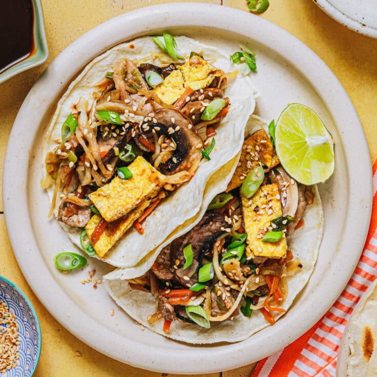 A plate of homemade moo shu pork served in pancakes.