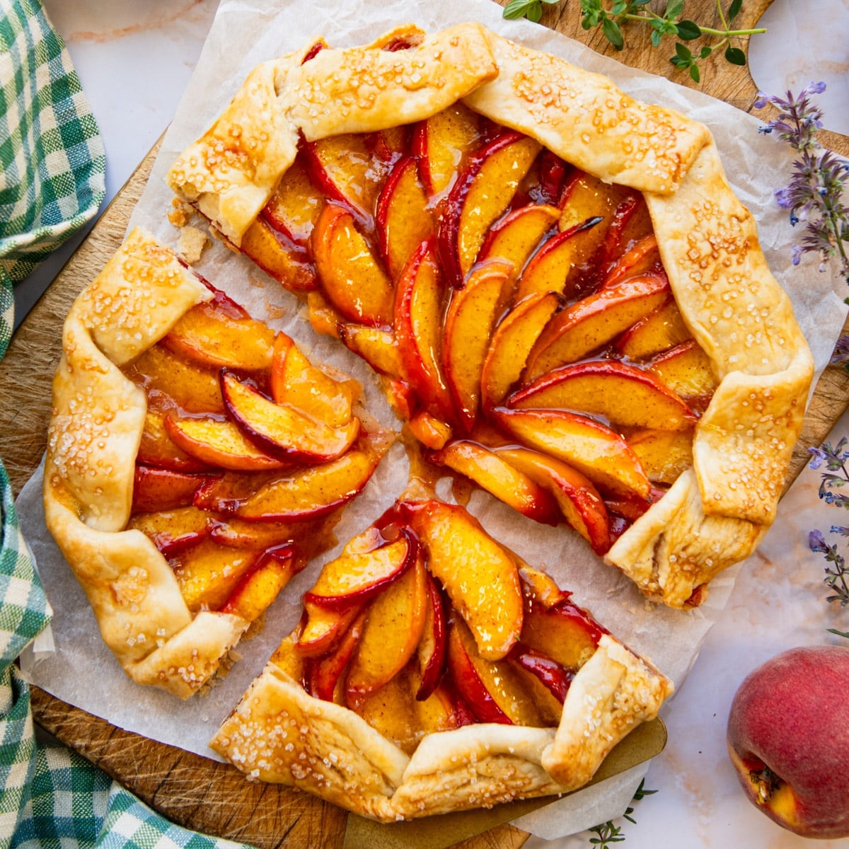 Square overhead shot of a sliced peach galette.