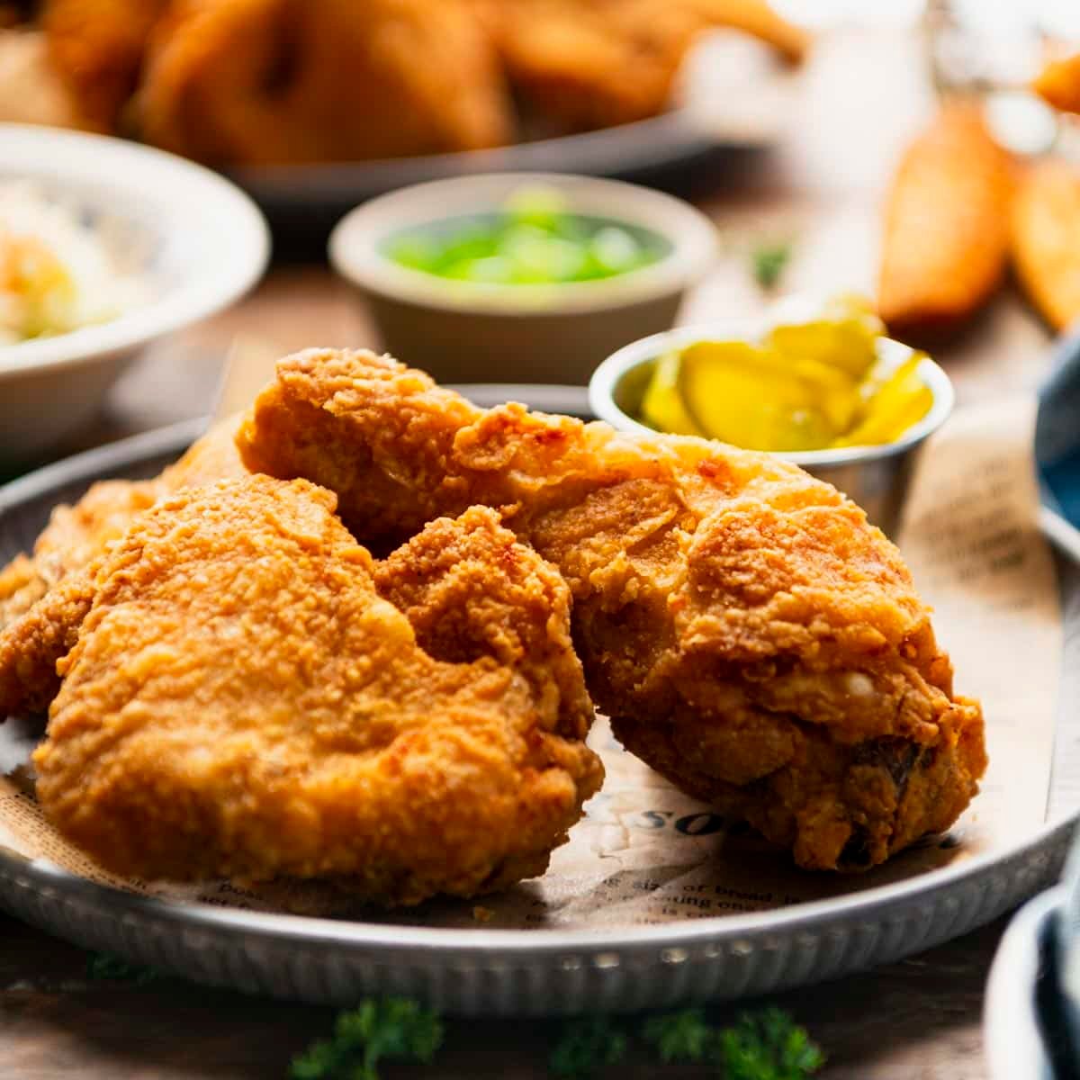 Square front shot of Southern fried chicken on a serving tray.