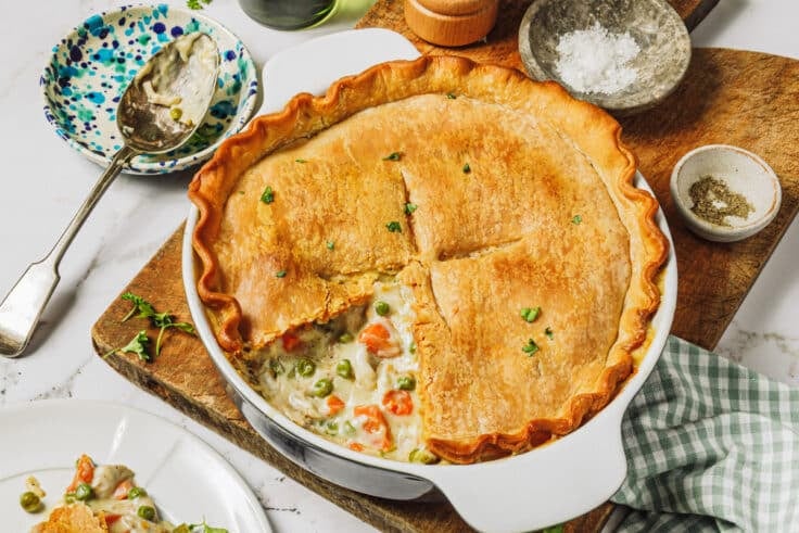 Horizontal side shot of a chicken pot pie on a table.