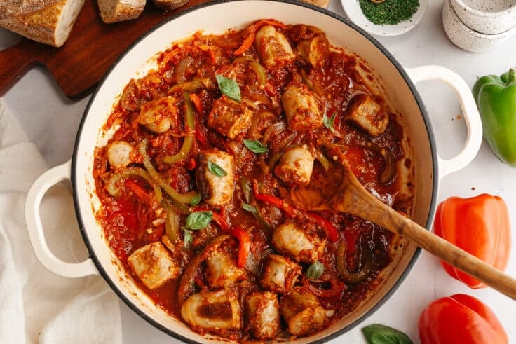 Horizontal overhead shot of a skillet full of Italian sausage and peppers.