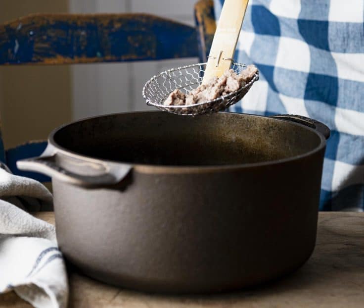 Browning Italian sausage in a cast iron Dutch oven.