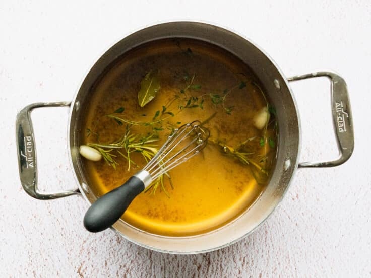 Whisking and simmering the pork chop brine in a saucepan.