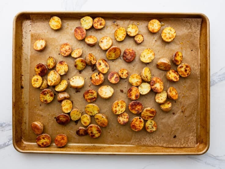 Roasted golden potatoes on a sheet pan.