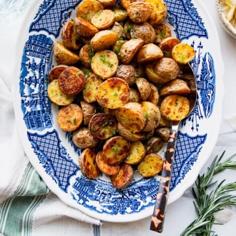 Close overhead shot of a tray of crispy roasted gold potatoes.