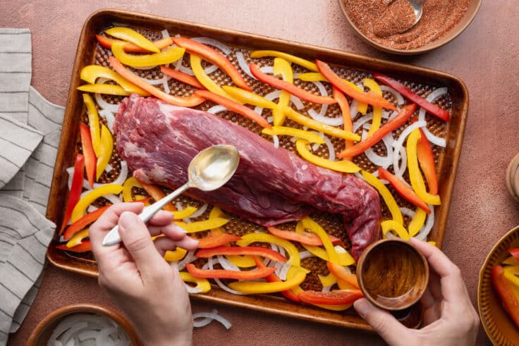 Adding seasoning to steak and veggies.