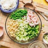 Process shot showing how to make shrimp pasta salad.