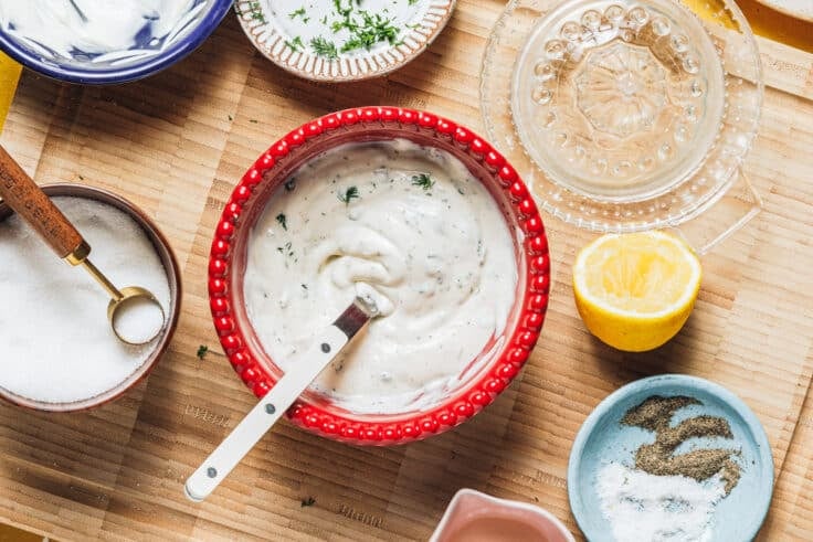 Stirring together the dressing for a shrimp pasta salad recipe.