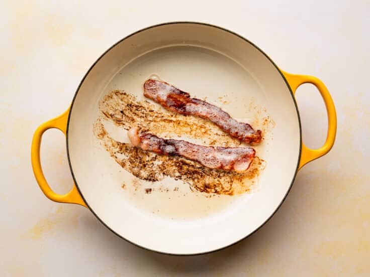 Cooking bacon in a skillet.