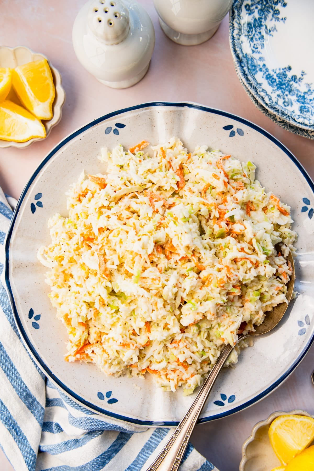 Overhead shot of a blue and white bowl full of homemade coleslaw.