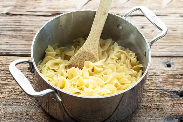 Cooked egg noodles in a pot.