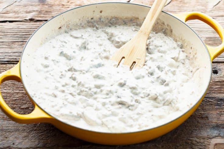 Ground beef and sour cream sauce in a skillet.