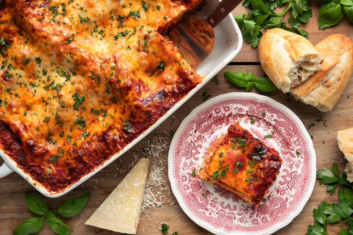 Horizontal overhead shot of a made from scratch lasagna recipe on a wooden table.
