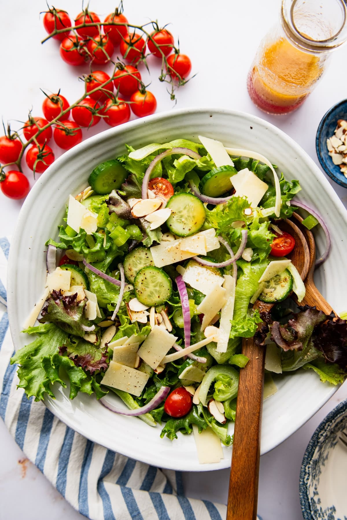 Overhead shot of a big green salad dressed in red wine vinegar salad dressing.
