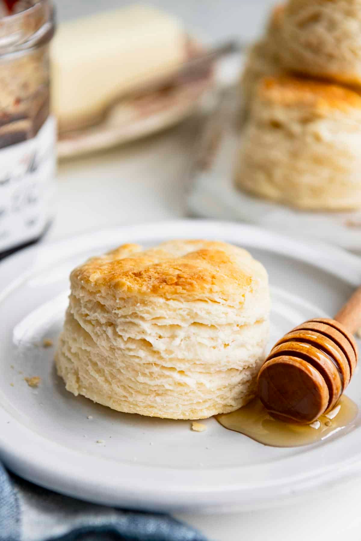 Front shot of the best 3-ingredient biscuit recipe served on a white plate with honey.