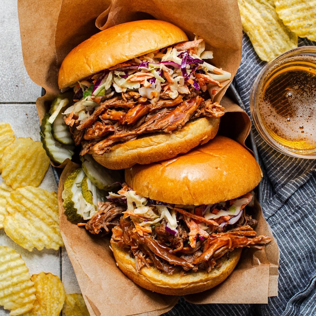 Square overhead shot of slow cooker pulled pork sandwiches.