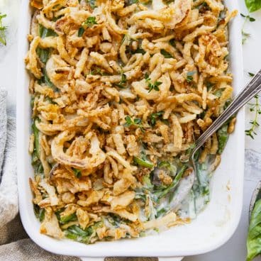 Square overhead shot of a green bean casserole with frozen green beans.