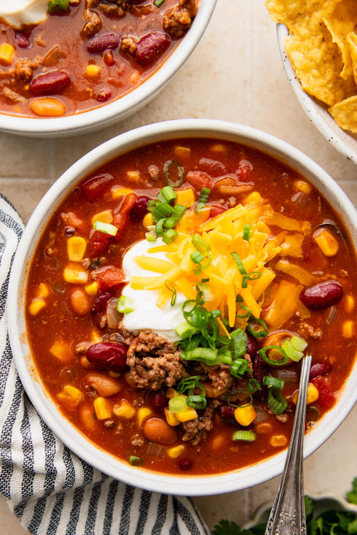 Close overhead shot of a bowl of taco soup with toppings.