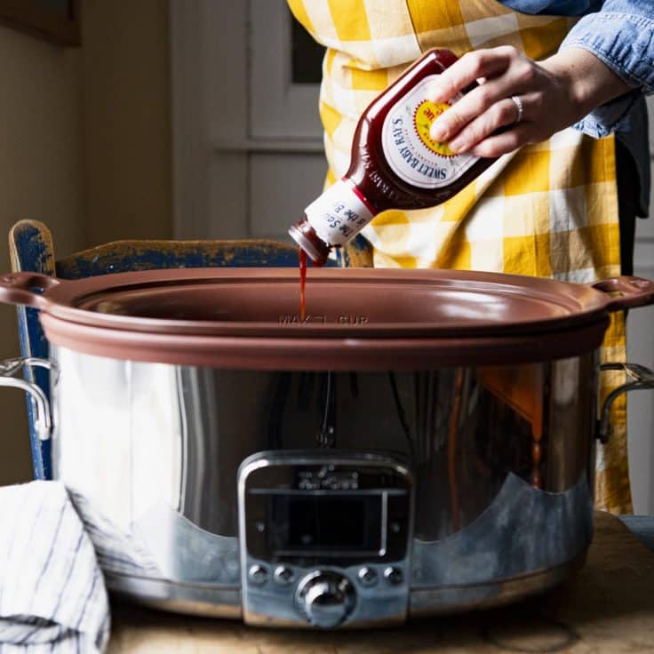 Pouring bbq sauce into a slow cooker.