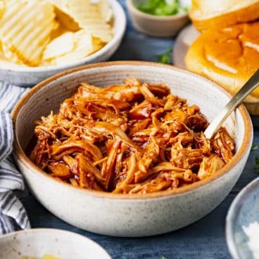 Square side shot of a bbq pulled chicken slow cooker recipe in a bowl.