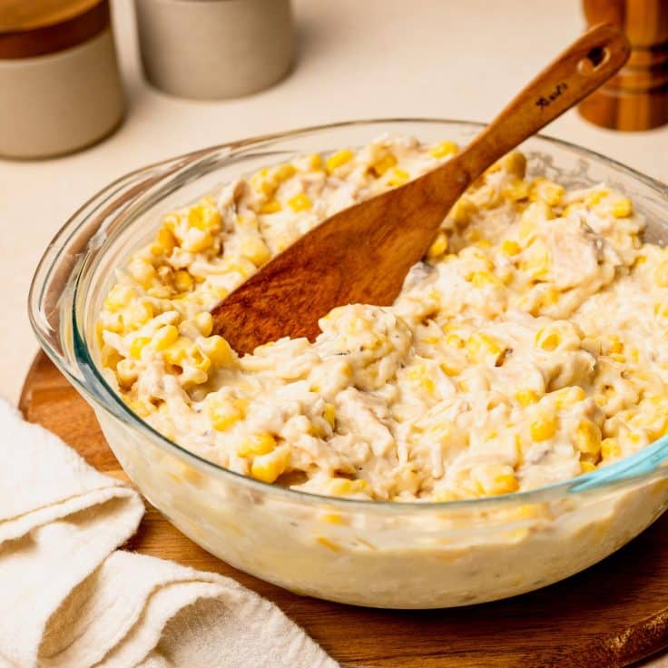 Process shot showing how to stir together the chicken filling for a chicken tater tot casserole recipe.