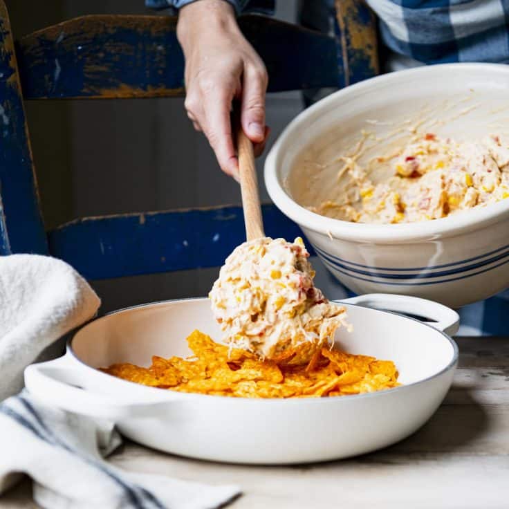 Process shot showing how to make a Dorito chicken bake casserole.