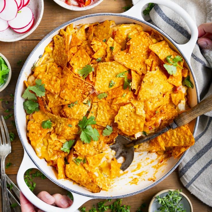 Square overhead shot of Dorito chicken casserole in a white dish.