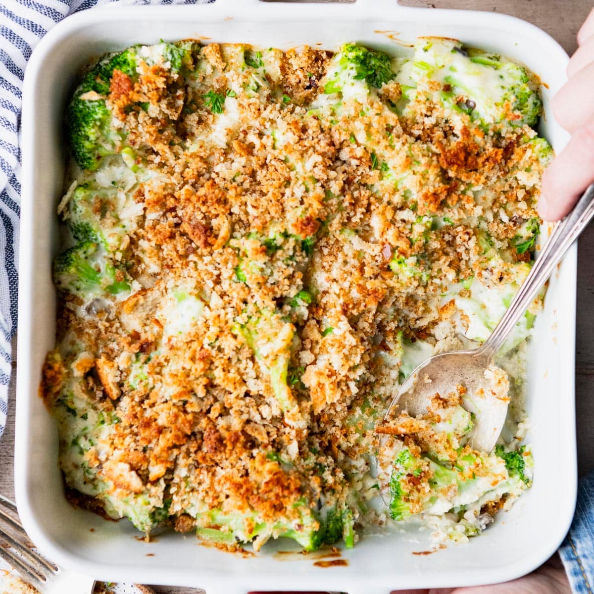 Square overhead shot of a white baking dish full of easy broccoli casserole.