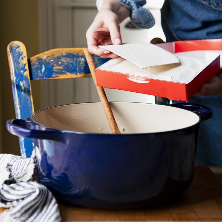 Process shot showing how to make chicken and dumplings with frozen dumplings.