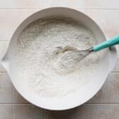 Whisking the dry ingredients for a flaky biscuits recipe.