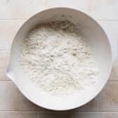 Cutting the butter into biscuit dough.