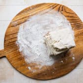 Stacking layers of biscuit dough to create flaky layers.