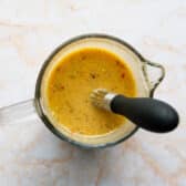 Whisking together the sauce for an easy baked pork chops recipe.