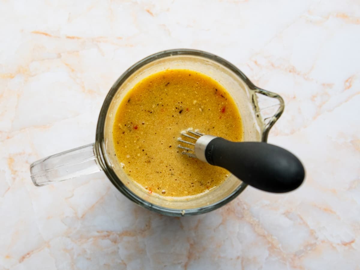 Whisking together the sauce for an easy baked pork chops recipe.