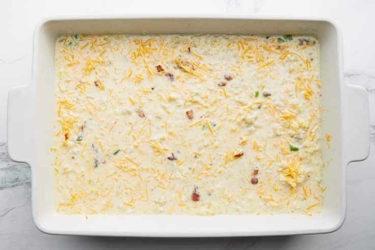 Overnight breakfast casserole in a dish before baking.