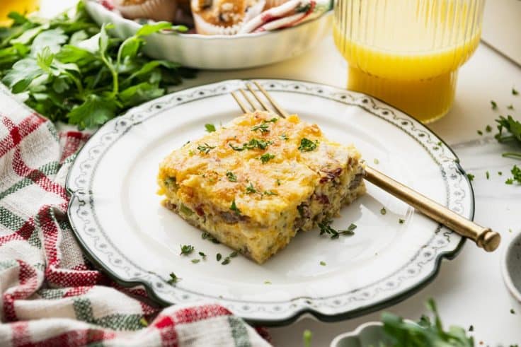 Slice of Bisquick breakfast casserole on a green and white plate.