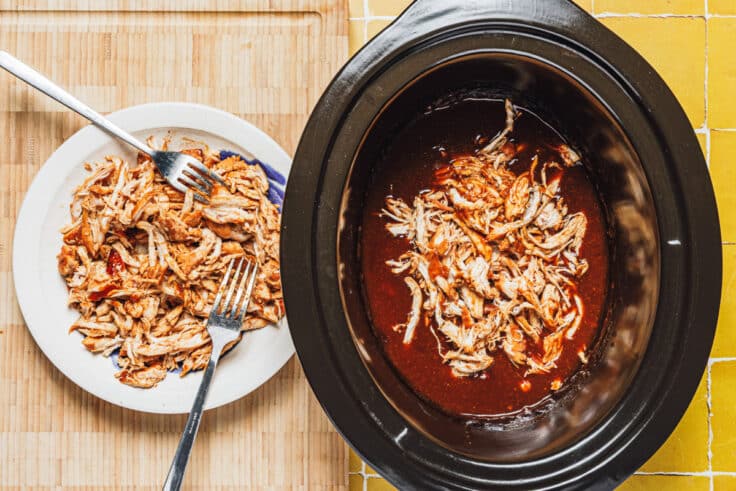 Shredding the chicken for a crock pot bbq pulled chicken recipe.
