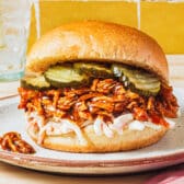 Square side shot of a sandwich made with crock pot bbq pulled chicken.